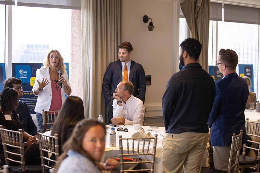 Sandy Lish, principal of the Castle Group, speaks with her student team.